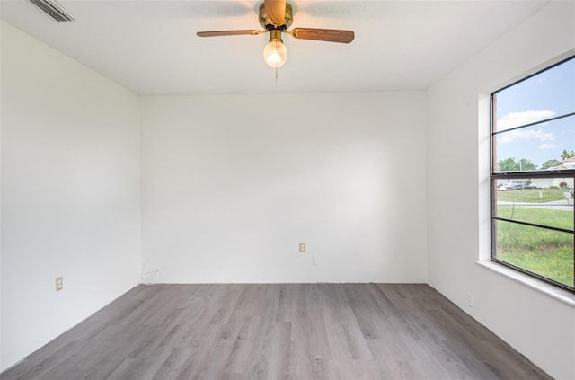 unfurnished room with light hardwood / wood-style flooring, a wealth of natural light, and ceiling fan