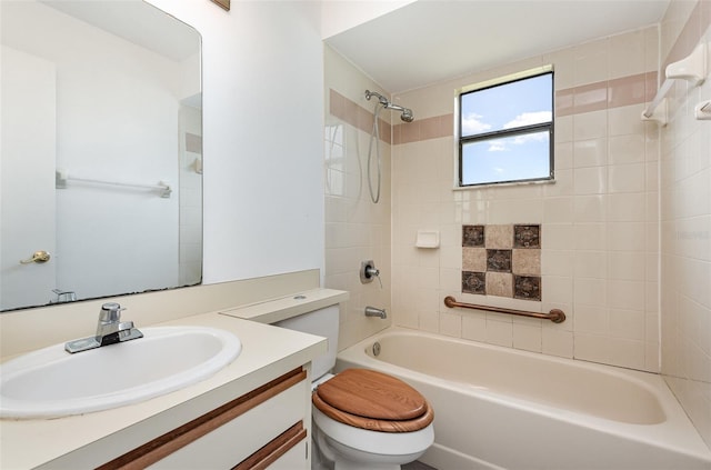 full bathroom featuring vanity, tiled shower / bath combo, and toilet