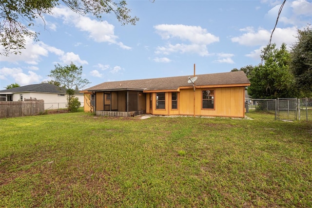 back of house featuring a lawn