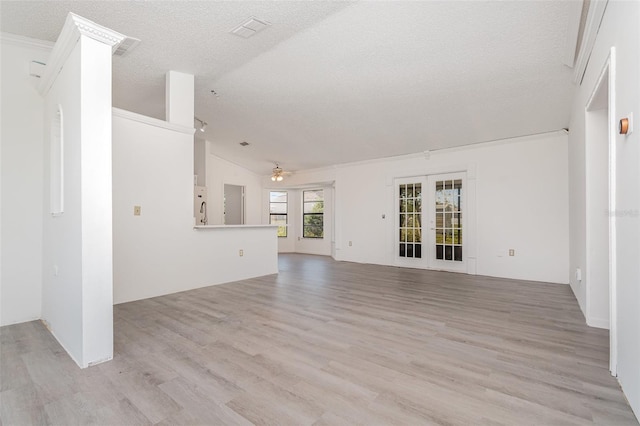 3186 Mapleshade St, Deltona, FL 32738 - unfurnished living room with lofted ceiling, a textured ceiling, ceiling fan, and light wood finished floors