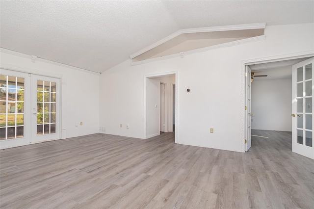 3186 Mapleshade St, Deltona, FL 32738 - unfurnished room with french doors, wood finished floors, vaulted ceiling, ornamental molding, and a textured ceiling