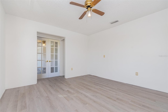 3186 Mapleshade St, Deltona, FL 32738 - spare room with french doors, wood finished floors, ceiling fan, and a textured ceiling