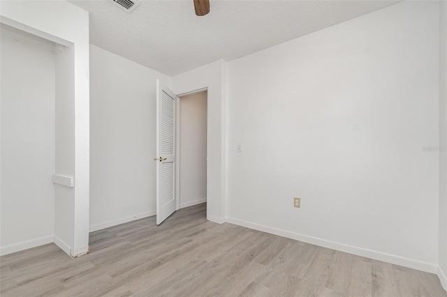 3186 Mapleshade St, Deltona, FL 32738 - spare room with light wood-style flooring, baseboards, ceiling fan, and a textured ceiling