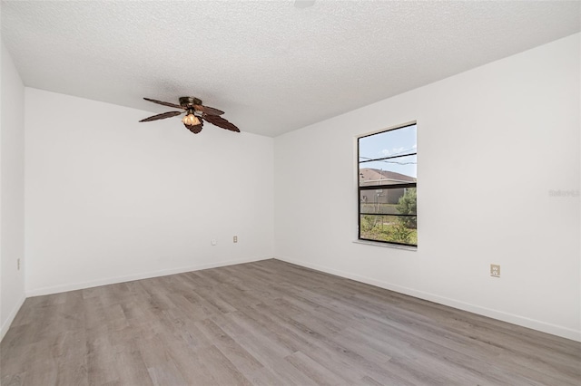 3186 Mapleshade St, Deltona, FL 32738 - spare room featuring wood finished floors, a ceiling fan, a textured ceiling, and baseboards