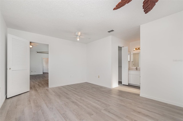 3186 Mapleshade St, Deltona, FL 32738 - empty room with ceiling fan, light wood-style flooring, a textured ceiling, and baseboards
