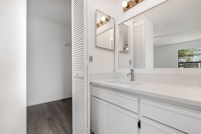 3186 Mapleshade St, Deltona, FL 32738 - bathroom featuring wood finished floors, vanity, a closet, and baseboards