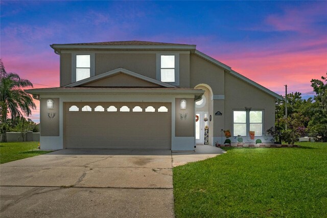 view of front of property featuring a lawn and a garage