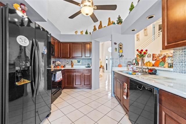 kitchen featuring ceiling fan, light tile patterned floors, sink, backsplash, and black appliances