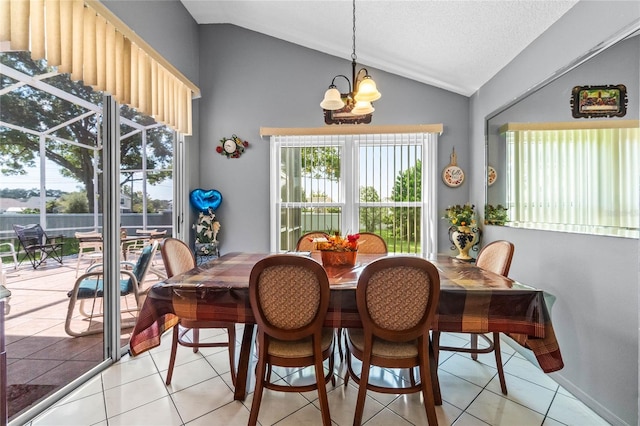 dining area with a wealth of natural light, lofted ceiling, and a chandelier