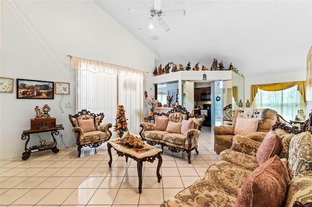 tiled living room featuring ceiling fan and high vaulted ceiling