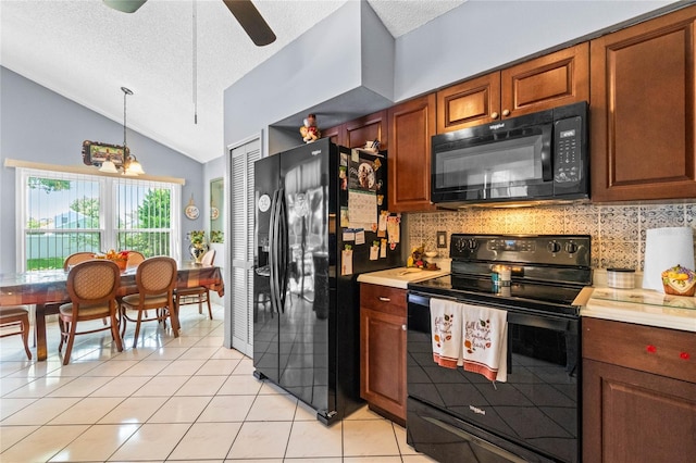 kitchen featuring pendant lighting, lofted ceiling, a textured ceiling, black appliances, and ceiling fan with notable chandelier