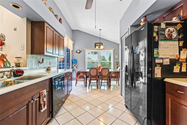 kitchen with ceiling fan, lofted ceiling, a textured ceiling, decorative light fixtures, and black appliances