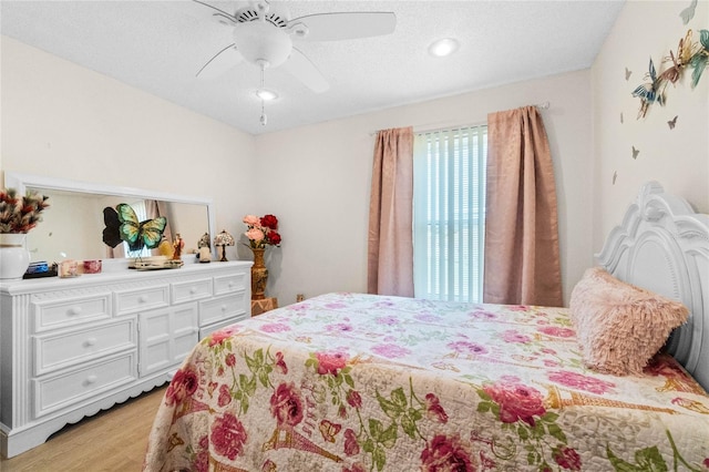 bedroom with light wood-type flooring and ceiling fan