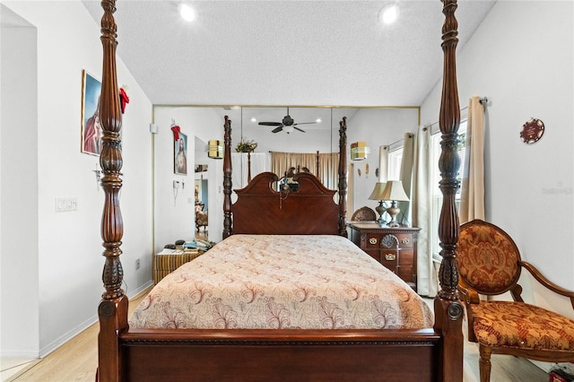 bedroom with light hardwood / wood-style floors and a textured ceiling