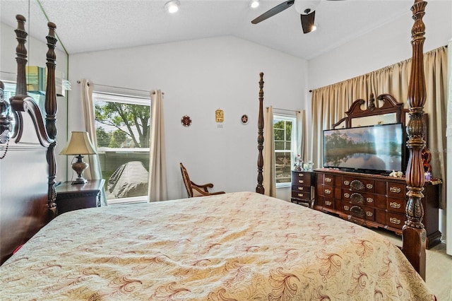 bedroom featuring vaulted ceiling, ceiling fan, carpet flooring, and a textured ceiling