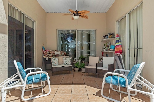 sunroom / solarium featuring ceiling fan