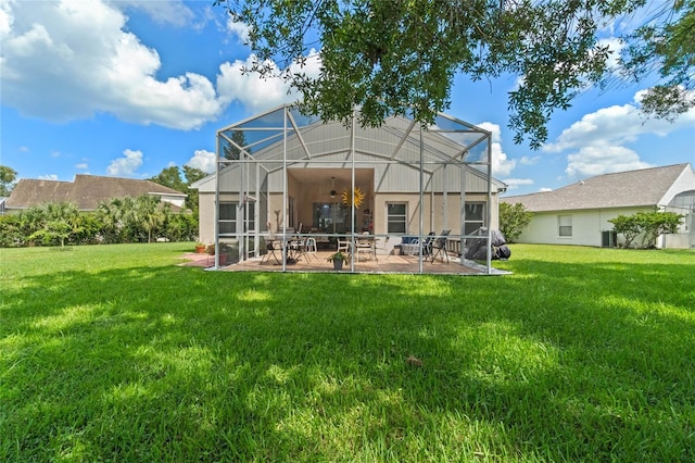 back of property featuring a lanai, central AC, a patio area, and a yard