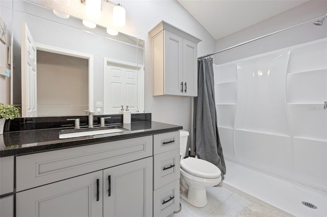 bathroom with a shower with curtain, vanity, lofted ceiling, toilet, and tile patterned floors