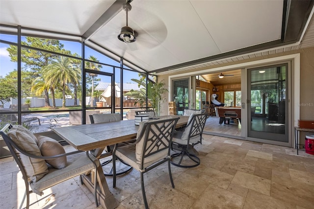 sunroom / solarium with ceiling fan, lofted ceiling, and a wealth of natural light