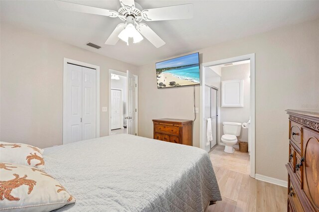 bedroom featuring a closet, light wood-type flooring, ceiling fan, and ensuite bathroom