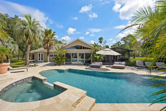 view of pool with an outdoor hangout area, an in ground hot tub, a patio area, and french doors