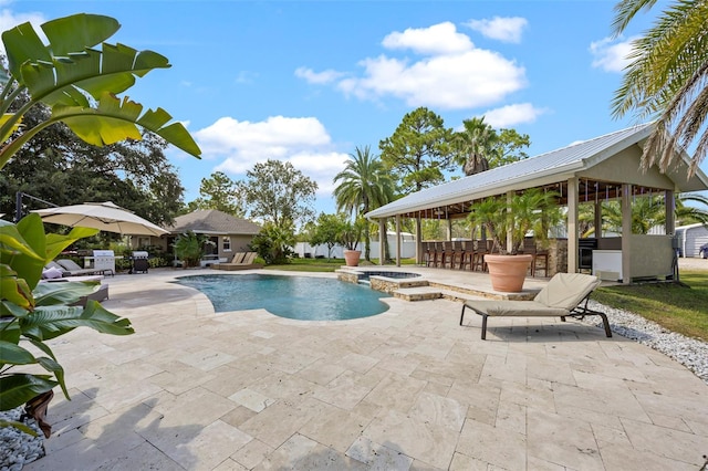 view of swimming pool featuring a patio, an in ground hot tub, and exterior bar