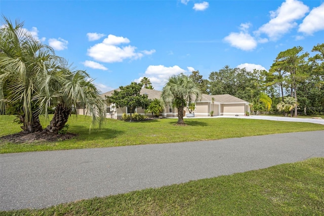 view of front of property with a front yard and a garage