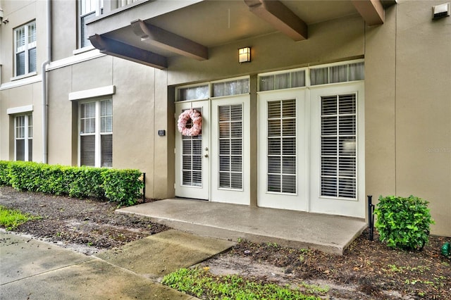 view of exterior entry featuring a patio area