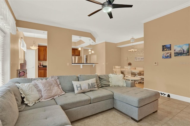 tiled living room with crown molding and ceiling fan with notable chandelier