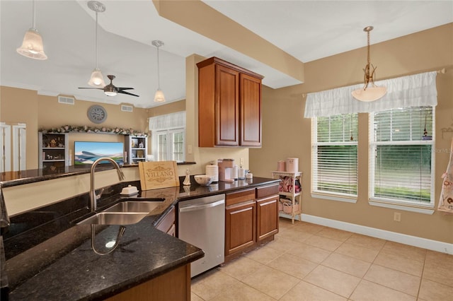 kitchen with hanging light fixtures, stainless steel dishwasher, dark stone countertops, and ceiling fan