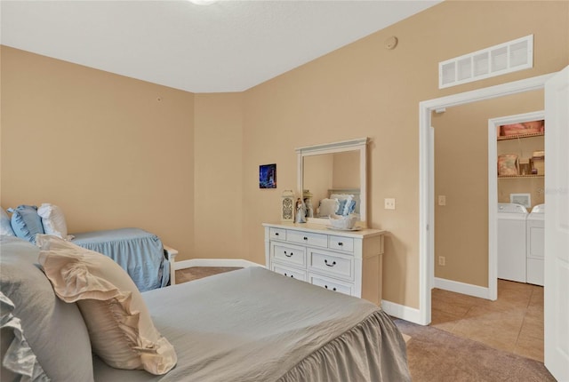 tiled bedroom featuring independent washer and dryer