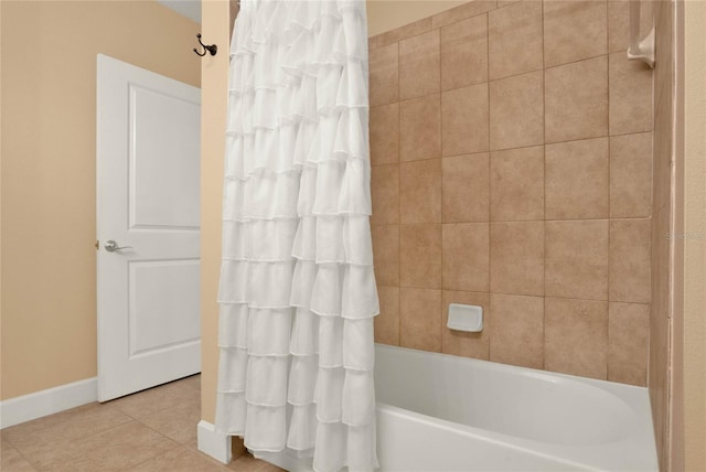 bathroom with shower / tub combo with curtain and tile patterned floors