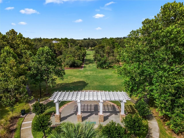 surrounding community with a yard and a patio