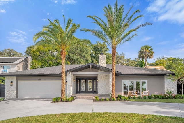 view of front of property with a garage and french doors