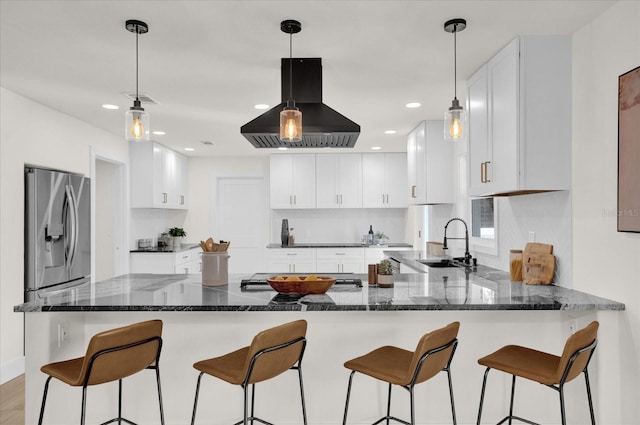 kitchen featuring white cabinets, sink, stainless steel fridge with ice dispenser, exhaust hood, and dark stone countertops