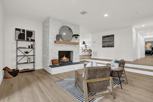 living room featuring a fireplace and light hardwood / wood-style flooring