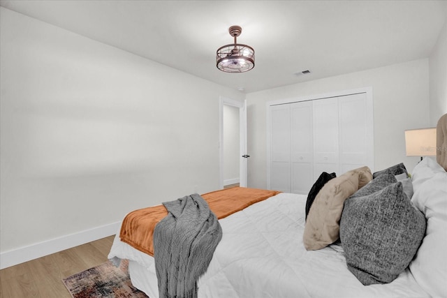 bedroom featuring hardwood / wood-style floors and a closet