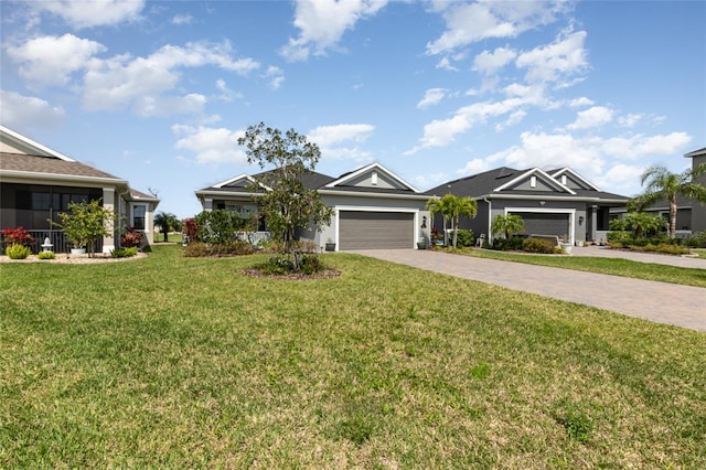 view of front of property featuring a front yard and a garage