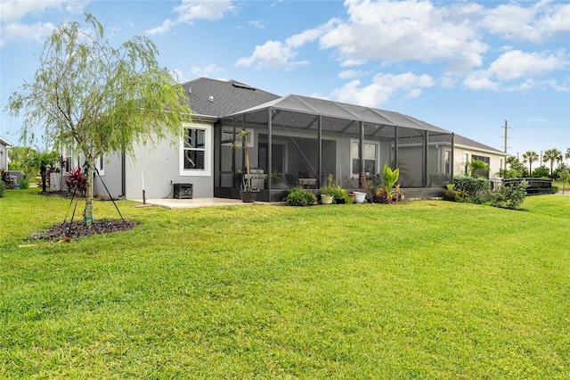 back of property with central AC, a lanai, and a lawn