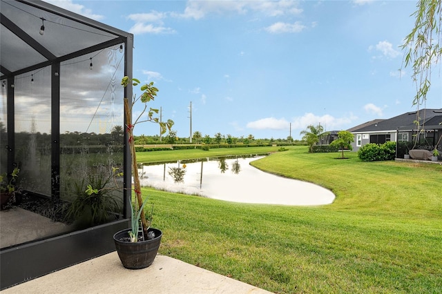 view of community featuring a yard and a water view