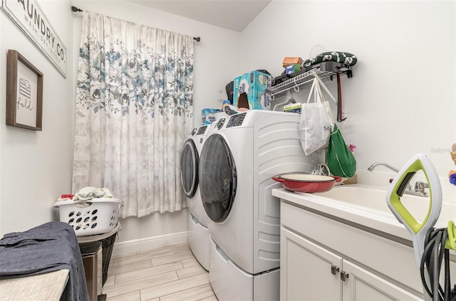 laundry room featuring cabinets and washer and clothes dryer