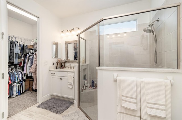 bathroom featuring tile patterned flooring, vanity, and an enclosed shower