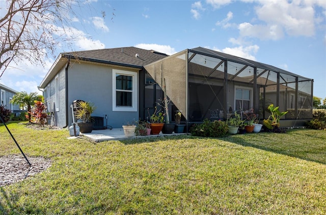 back of property featuring a yard, a patio, and a lanai