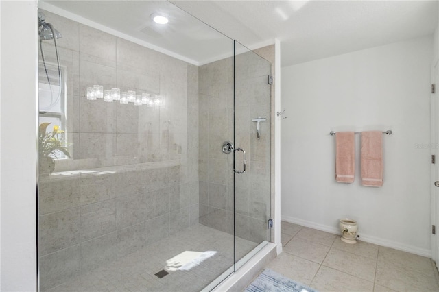 bathroom with a shower with door and tile patterned floors