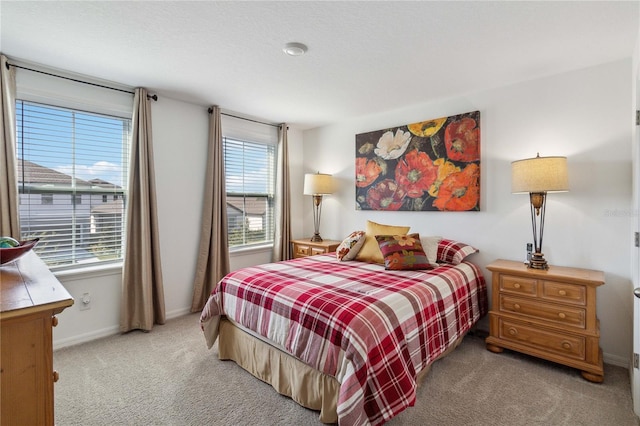 carpeted bedroom featuring multiple windows