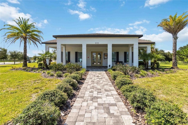 view of front of home with french doors and a front yard