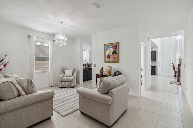 living room featuring light tile patterned flooring and an inviting chandelier