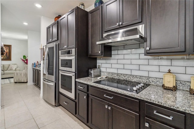 kitchen featuring tasteful backsplash, dark brown cabinetry, stainless steel appliances, and light tile patterned floors