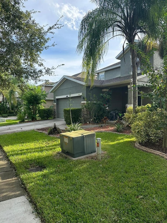 view of front facade featuring a front yard and a garage