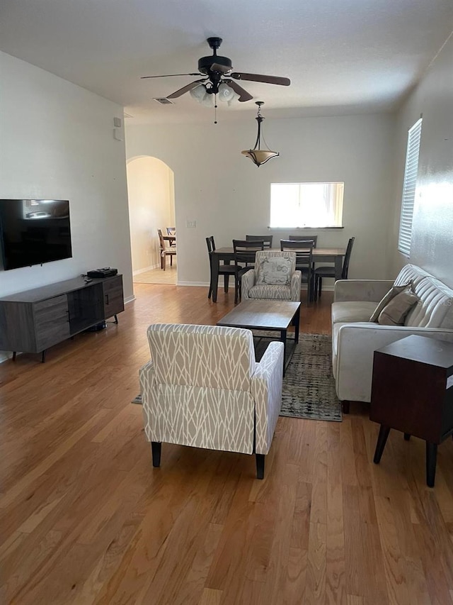 living room with ceiling fan and wood-type flooring